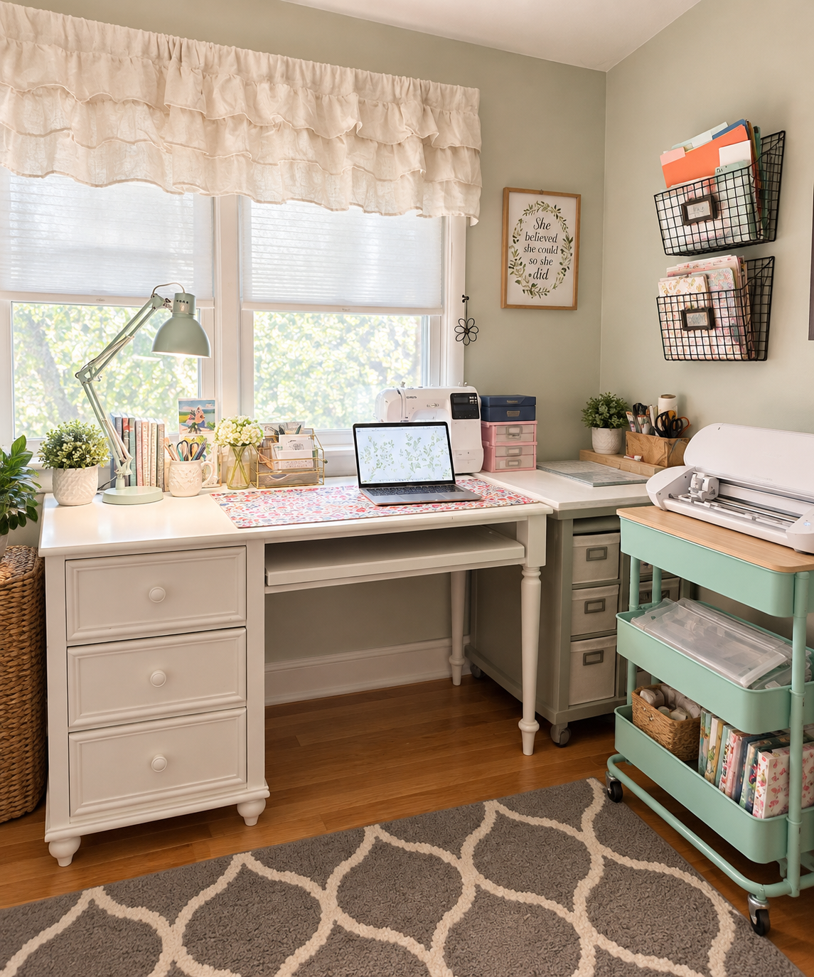A styled home office corner featuring a white writing desk with drawers, a mint green rolling cart, a window with a ruffled cream valance, and various desk accessories and storage baskets.